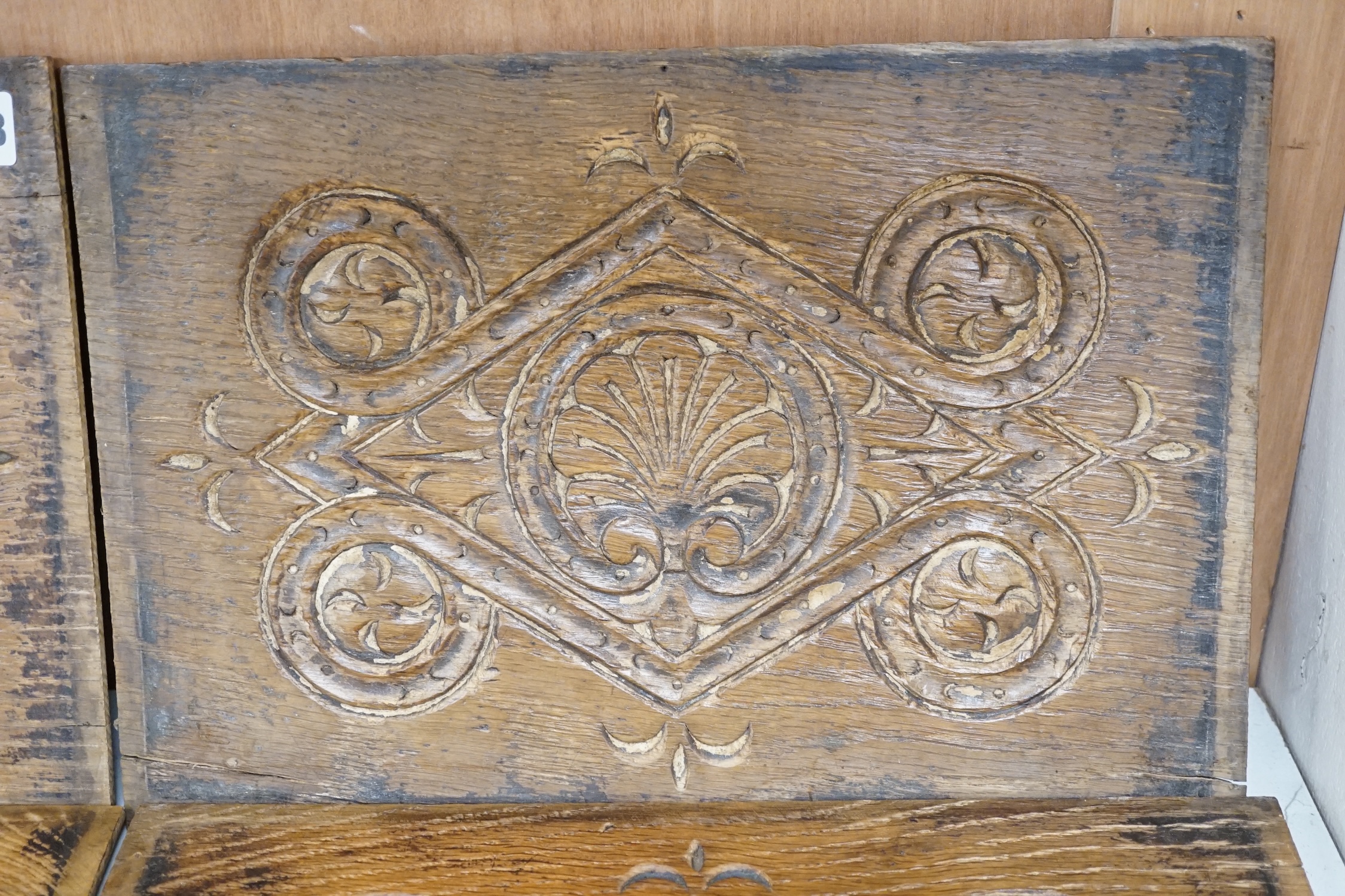 A set of four 18th century carved oak panels, 37cm x 25cm. Condition - two have splits